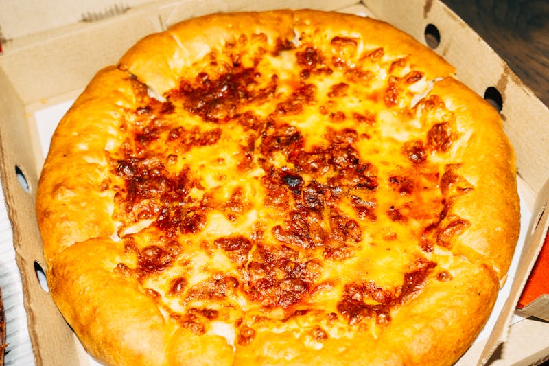 Five Cheese Supreme pizza with golden crust